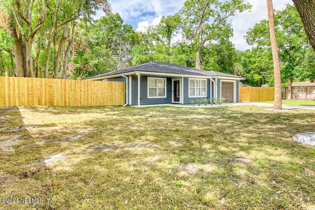 single story home featuring a front yard and a garage