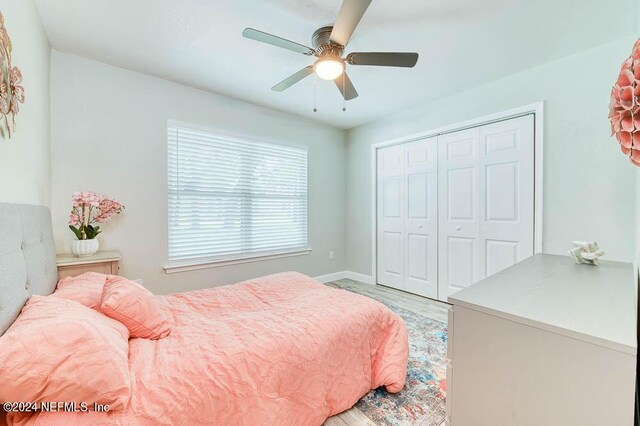 bedroom with a closet, ceiling fan, and hardwood / wood-style flooring