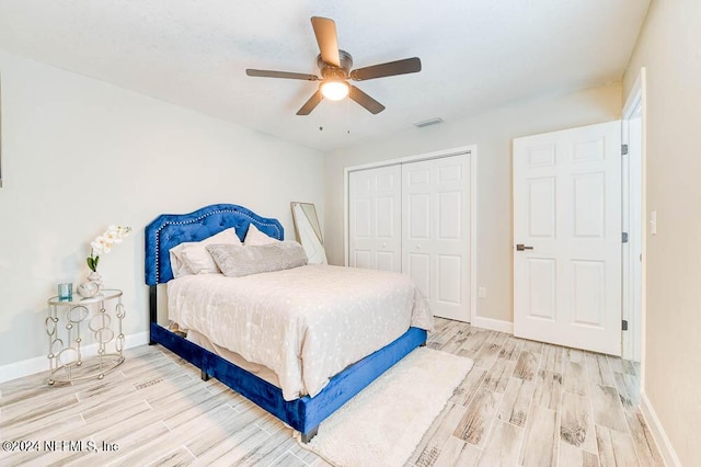 bedroom with ceiling fan, a closet, and light hardwood / wood-style floors