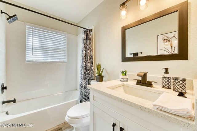 full bathroom featuring shower / bathtub combination with curtain, wood-type flooring, vanity, and toilet