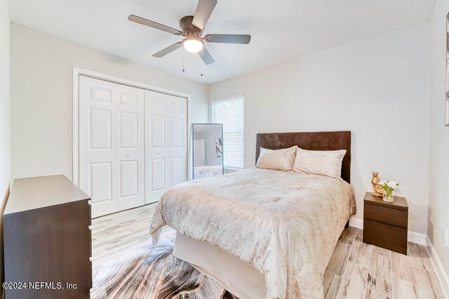 bedroom featuring a closet, ceiling fan, and light hardwood / wood-style flooring