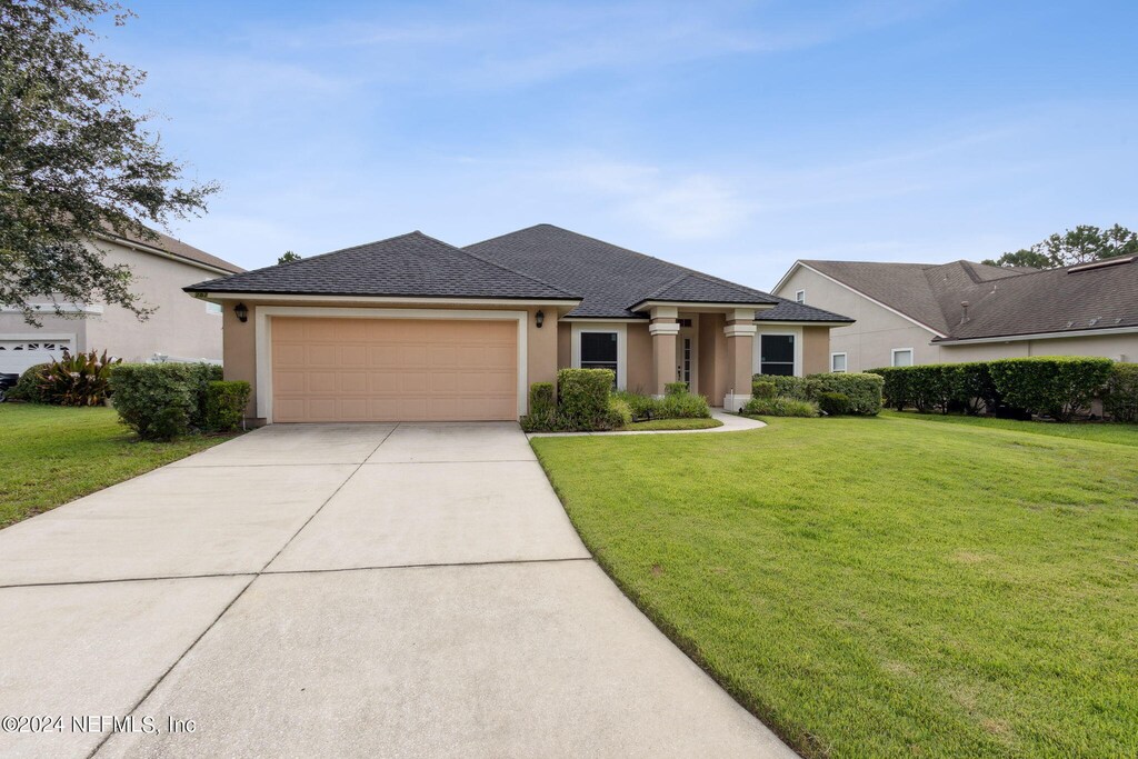 view of front facade with a front lawn and a garage