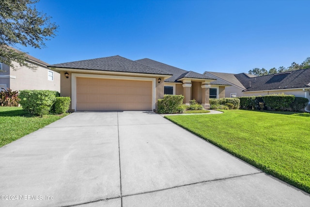 view of front of house featuring a front yard and a garage