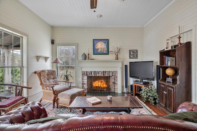 living room with a fireplace and wood finished floors