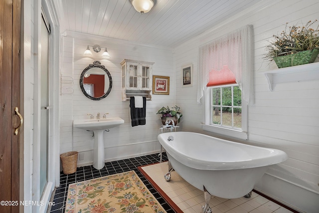 bathroom featuring wooden ceiling, tile patterned flooring, and a freestanding bath