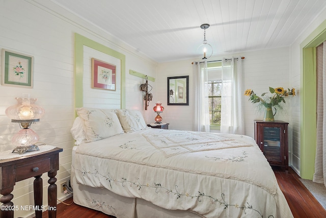 bedroom with dark wood-style floors and ornamental molding