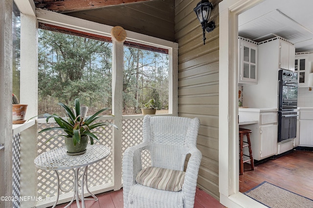 exterior space with wooden walls and hardwood / wood-style flooring