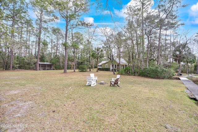 view of yard with a fire pit