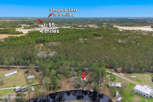 bird's eye view featuring a water view and a wooded view