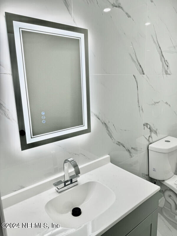 bathroom with toilet and vanity