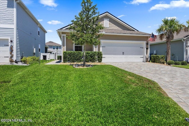 view of front of property with a front yard and a garage