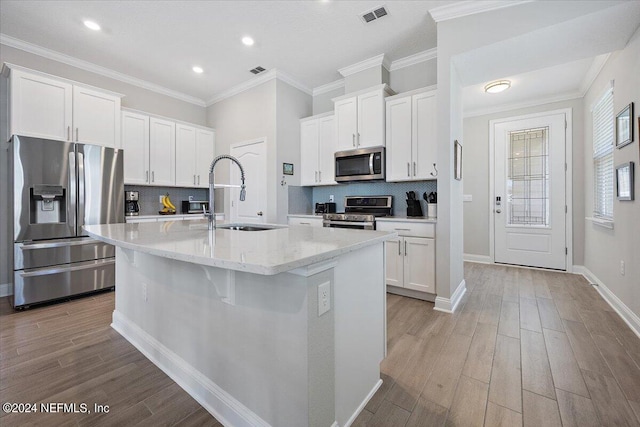 kitchen featuring white cabinetry, sink, an island with sink, and appliances with stainless steel finishes