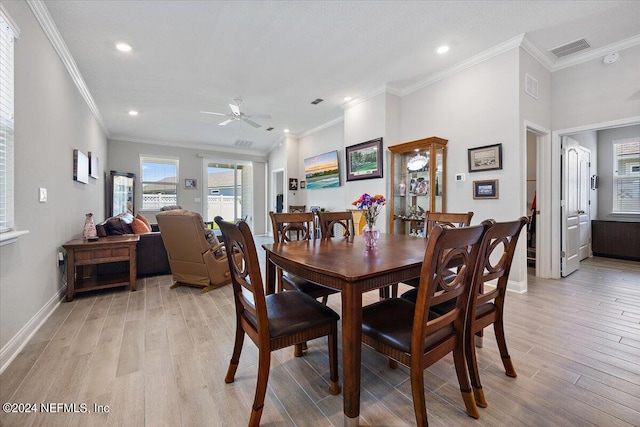 dining area with ceiling fan, crown molding, and light hardwood / wood-style floors