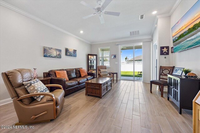 living room featuring ceiling fan, light wood-type flooring, and ornamental molding