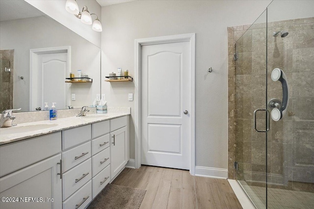 bathroom with vanity, hardwood / wood-style flooring, and an enclosed shower