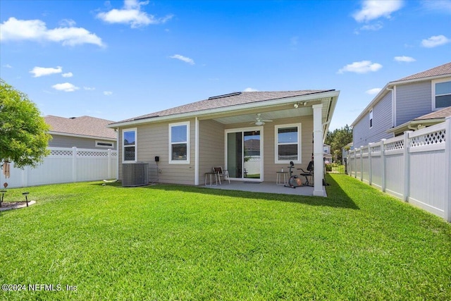 rear view of house featuring a lawn, ceiling fan, a patio area, and central AC