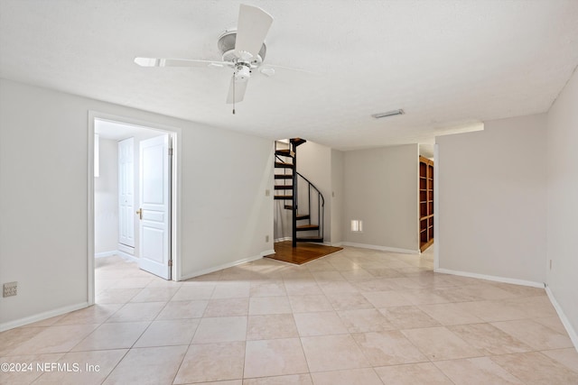 interior space with ceiling fan and light tile patterned floors