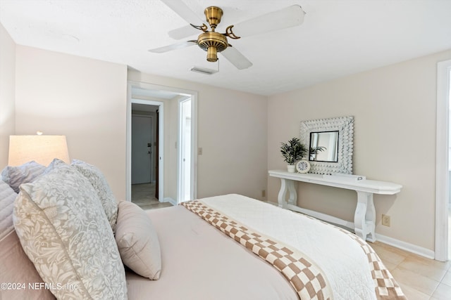 tiled bedroom with ceiling fan