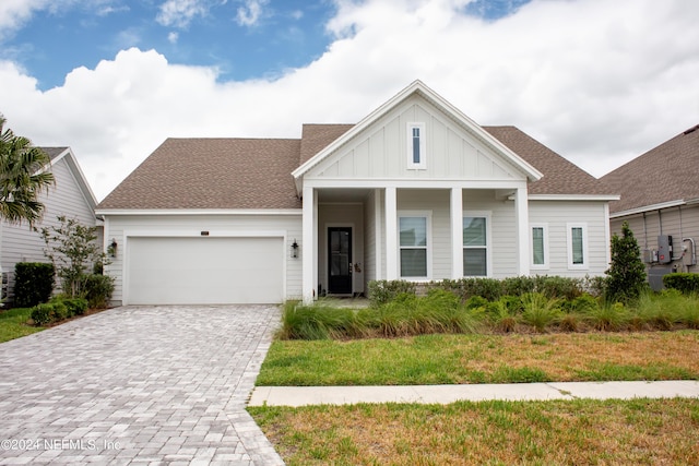 view of front facade with a garage and a front lawn