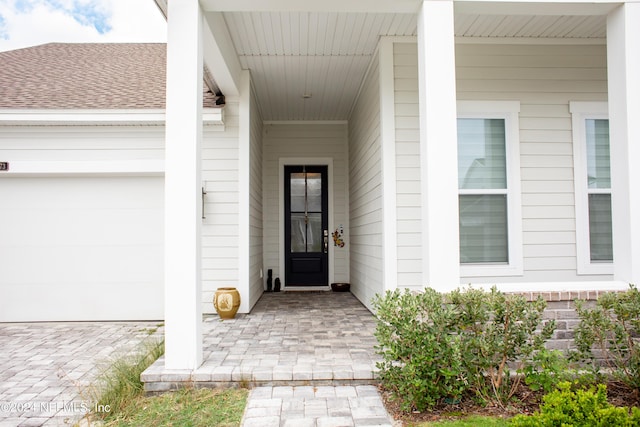 view of exterior entry featuring a garage