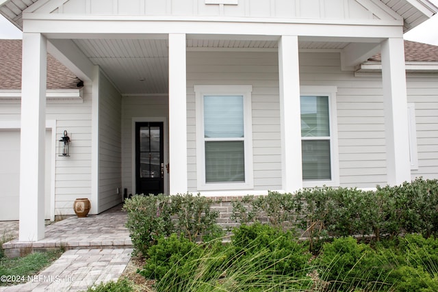 view of exterior entry with a porch