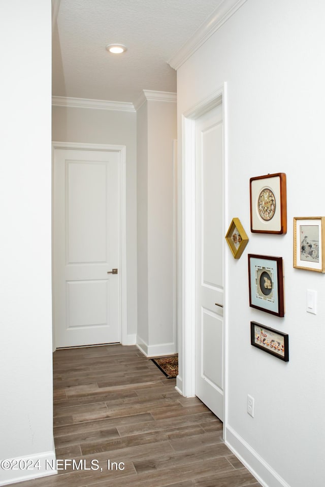 hall with crown molding and hardwood / wood-style flooring