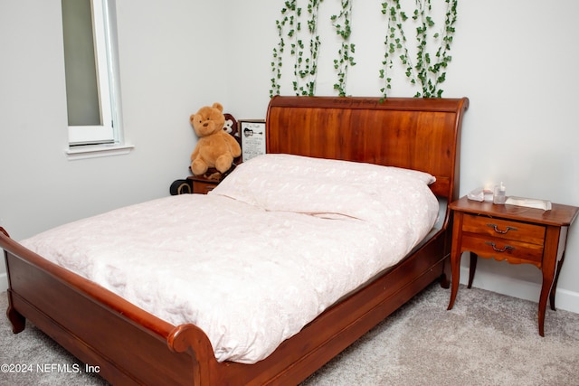 bedroom featuring light colored carpet