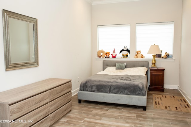 bedroom with multiple windows and crown molding