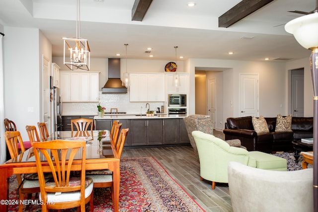 dining room with beamed ceiling, sink, and a chandelier