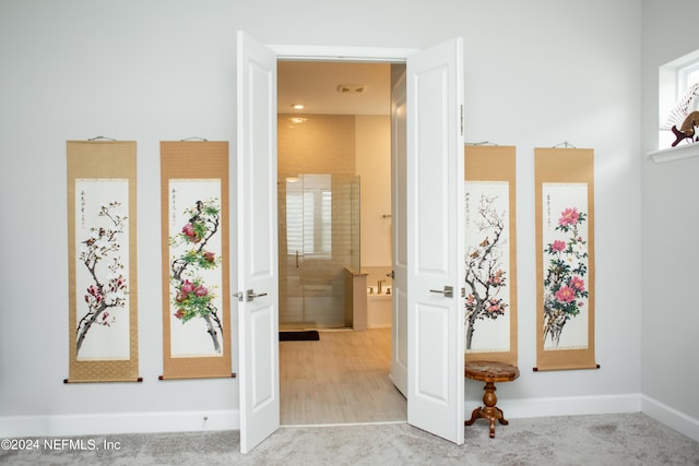 hallway featuring light carpet