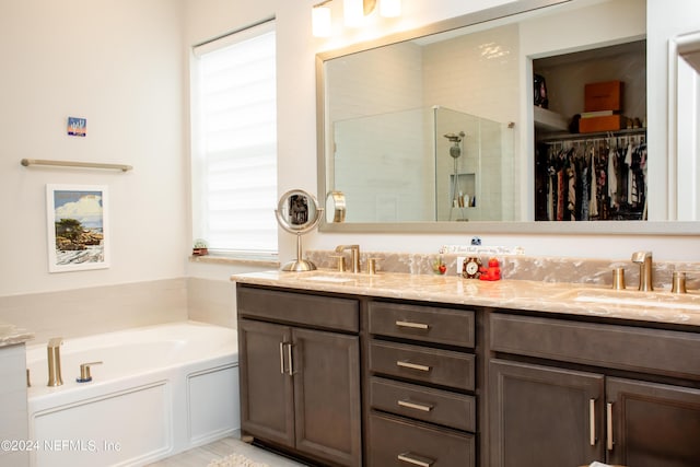 bathroom featuring vanity and independent shower and bath