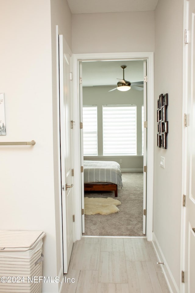 hallway with light colored carpet