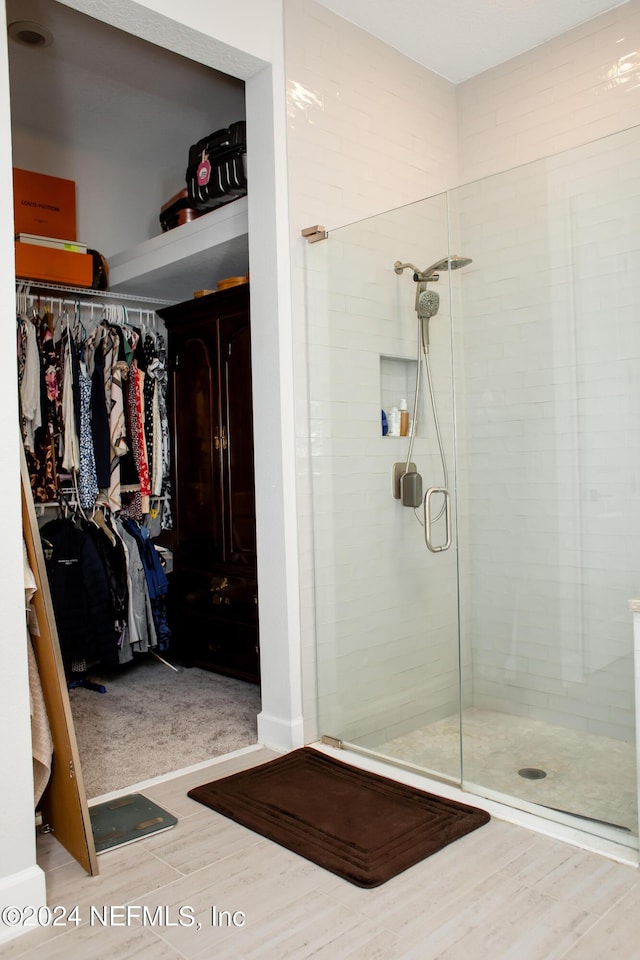 bathroom with hardwood / wood-style floors and walk in shower