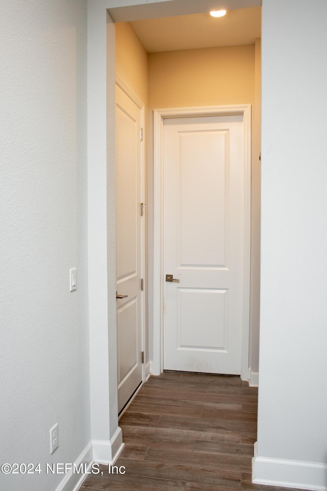 corridor featuring dark hardwood / wood-style floors