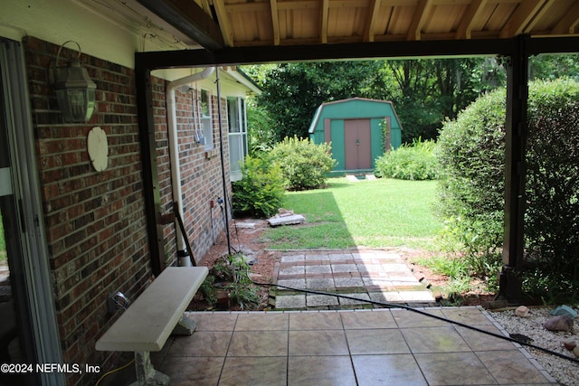 view of patio with a storage shed and an outbuilding