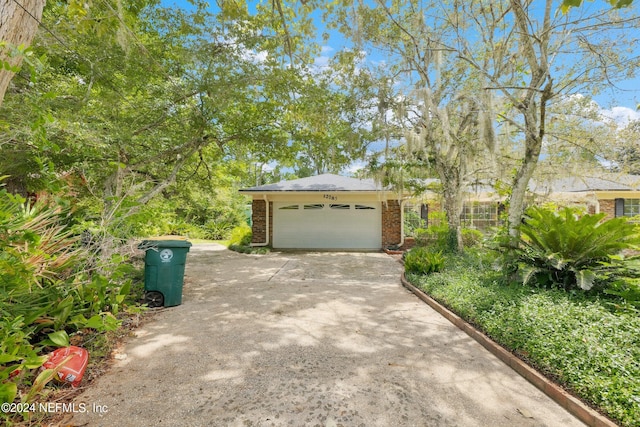 view of front facade with concrete driveway, brick siding, and an attached garage