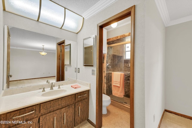 bathroom featuring toilet, vanity, baseboards, ornamental molding, and a stall shower