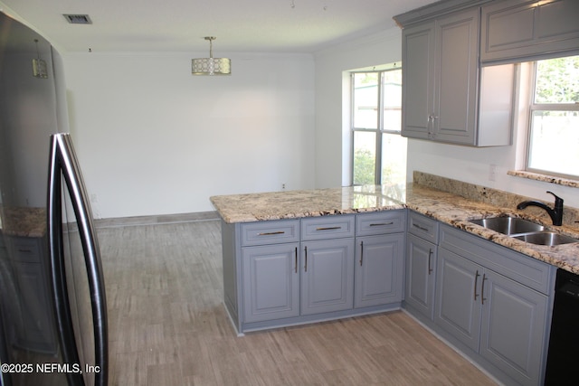 kitchen featuring dishwasher, a peninsula, crown molding, gray cabinetry, and a sink