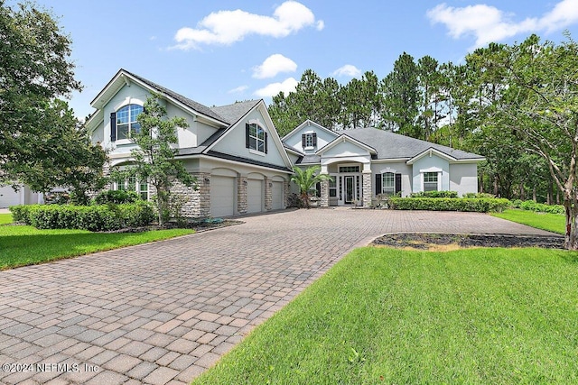 view of front facade with a garage and a front lawn