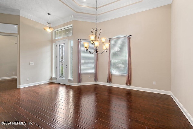 unfurnished room with a chandelier, hardwood / wood-style floors, a tray ceiling, and ornamental molding