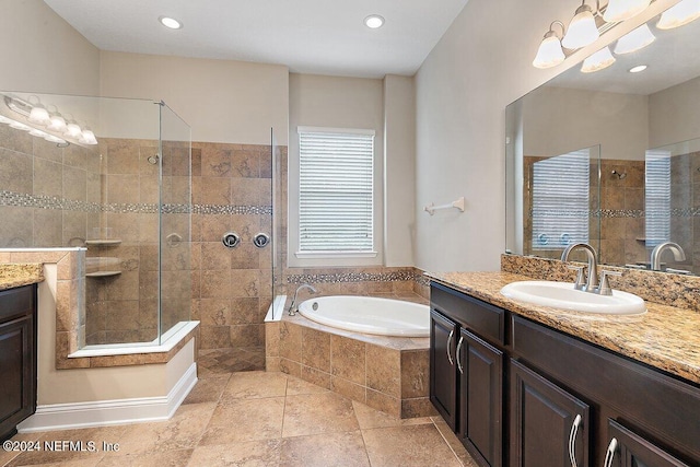 bathroom with tile patterned floors, vanity, and shower with separate bathtub