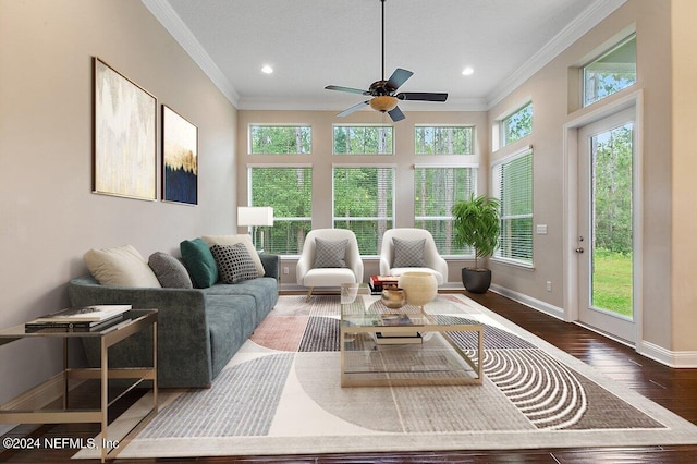 living room featuring ceiling fan, dark hardwood / wood-style flooring, and ornamental molding