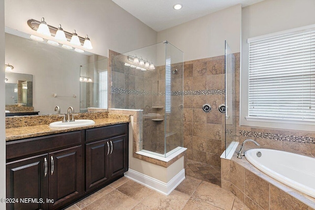 bathroom featuring vanity and separate shower and tub