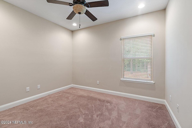 spare room featuring carpet floors and ceiling fan