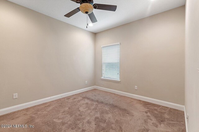 unfurnished room with carpet and ceiling fan