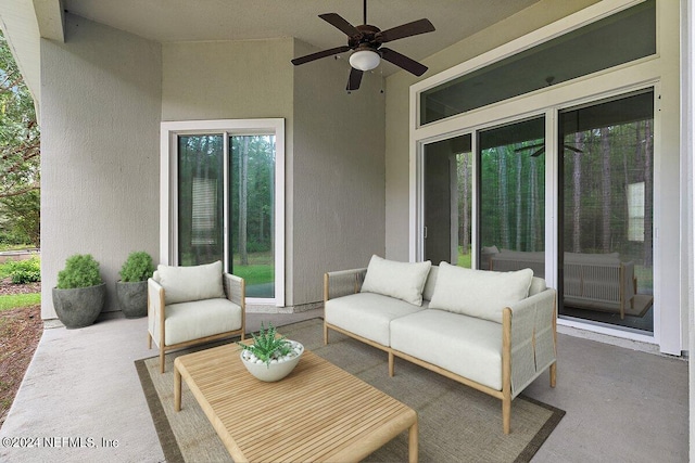 view of patio with an outdoor living space and ceiling fan