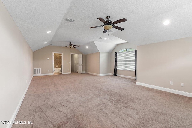 bonus room with a textured ceiling, light colored carpet, ceiling fan, and lofted ceiling