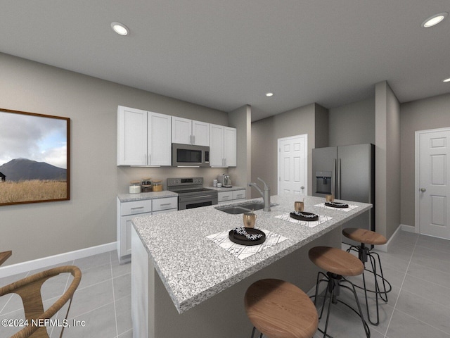 kitchen featuring stainless steel appliances, white cabinetry, a kitchen island with sink, and sink