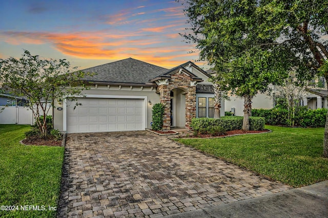 view of front of house with a yard and a garage