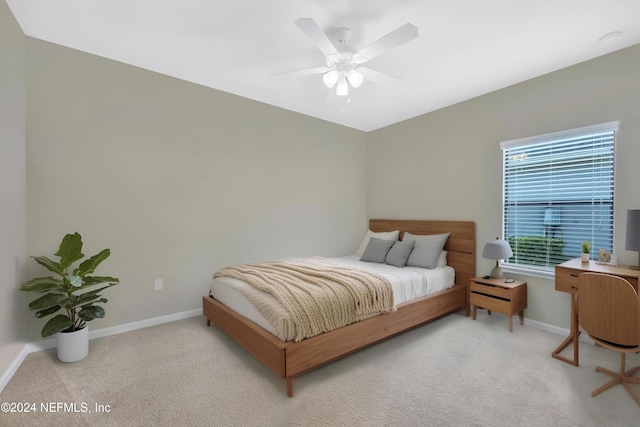 bedroom with ceiling fan and light colored carpet